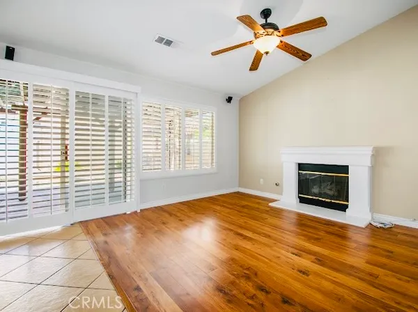 a view of a livingroom with a fireplace and a ceiling fan