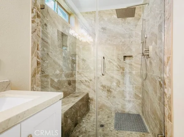 a bathroom with a granite countertop shower