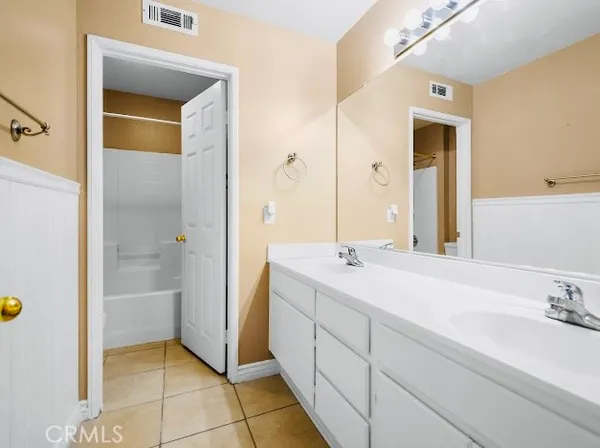 a bathroom with a sink a mirror and a shower