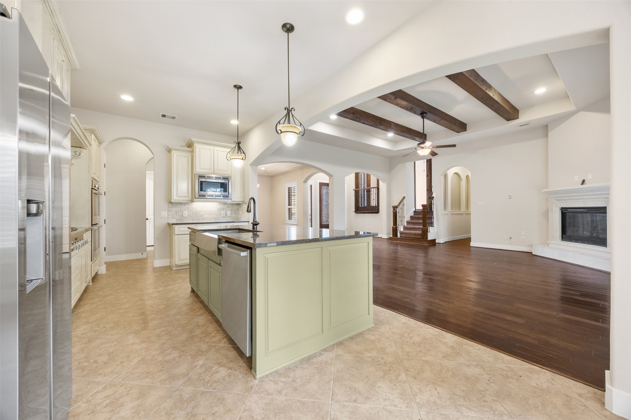 6515 Fraser Point Spring, TX 77379 - Photo 7 of 39 a kitchen with stainless steel appliances kitchen island a refrigerator and a view of living room