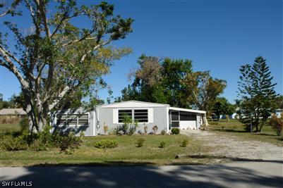 5808 Sailfish Road Bokeelia, FL 33922 - Photo 1 of 9 front view of a house with a big yard