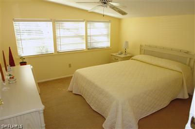 5808 Sailfish Road Bokeelia, FL 33922 - Photo 4 of 9 a bed sitting in a bedroom next to a window