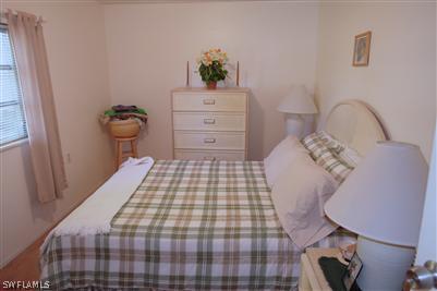 5808 Sailfish Road Bokeelia, FL 33922 - Photo 5 of 9 a bedroom with a bed and a dresser