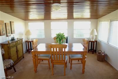 5808 Sailfish Road Bokeelia, FL 33922 - Photo 8 of 9 a view of a dining room with furniture and window