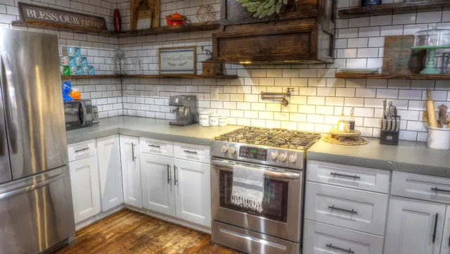 a kitchen with stainless steel appliances a refrigerator and a sink