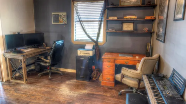 a bathroom with a granite countertop sink a toilet and shower