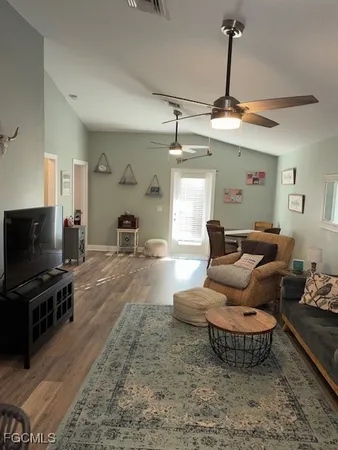 a living room with furniture a rug and a window
