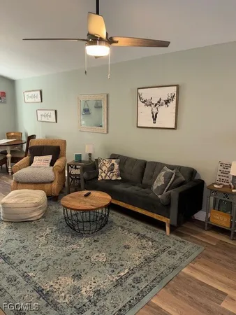 a living room with lots of furniture and kitchen view