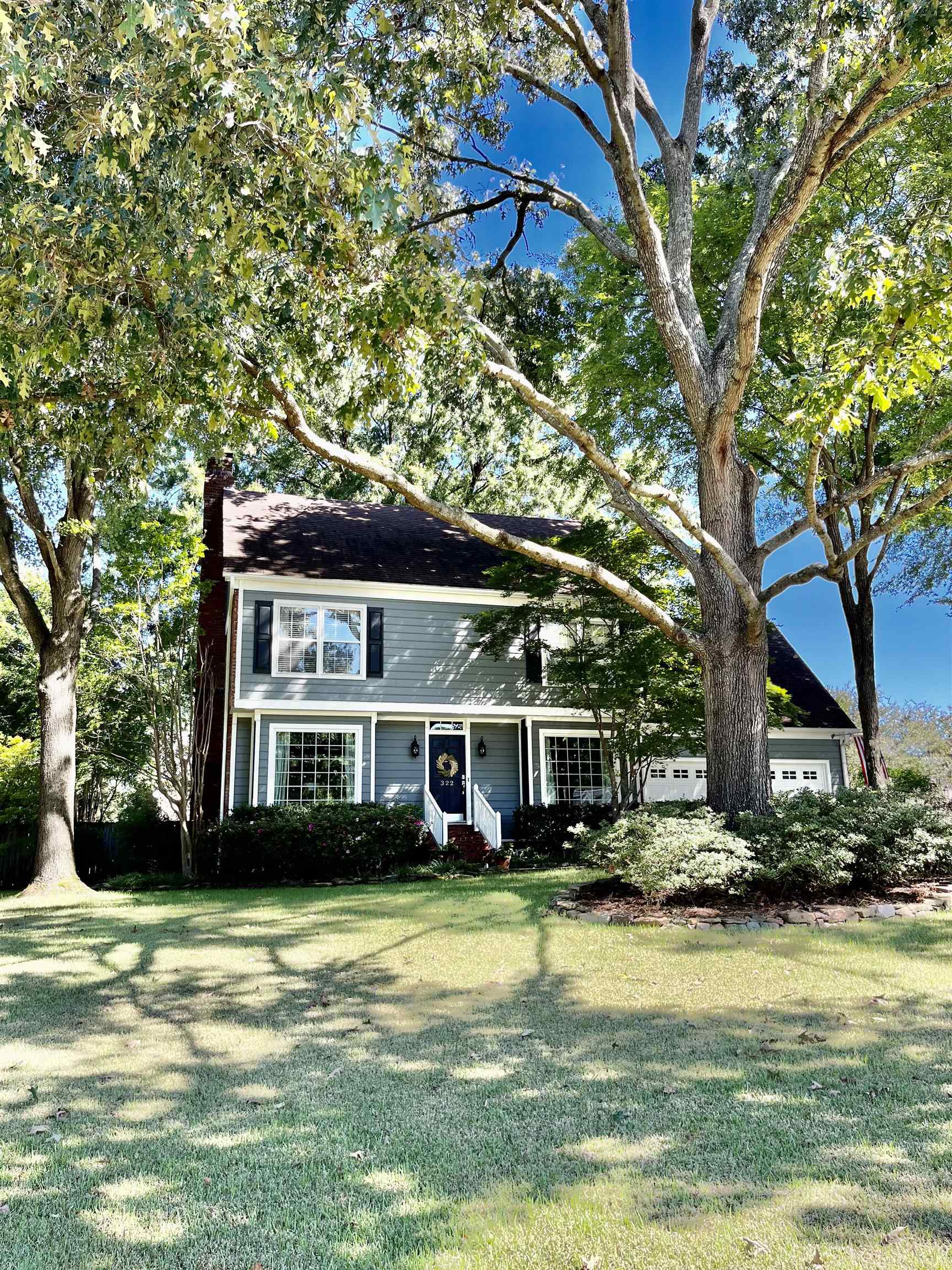 322 Spring Mill Road Collierville, TN 38017 - Photo 1 of 21 a front view of a house with a yard table and chairs