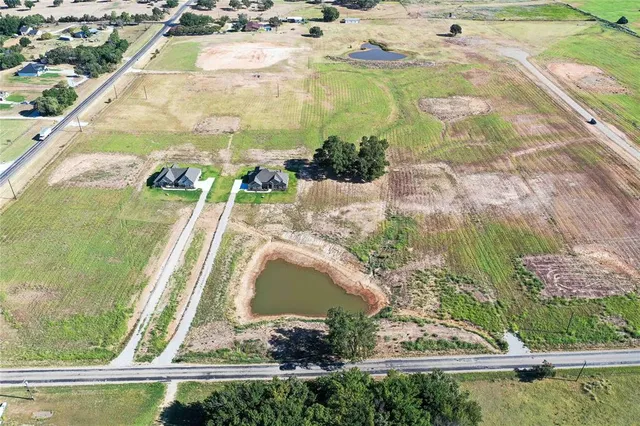 an aerial view of a residential houses with outdoor space