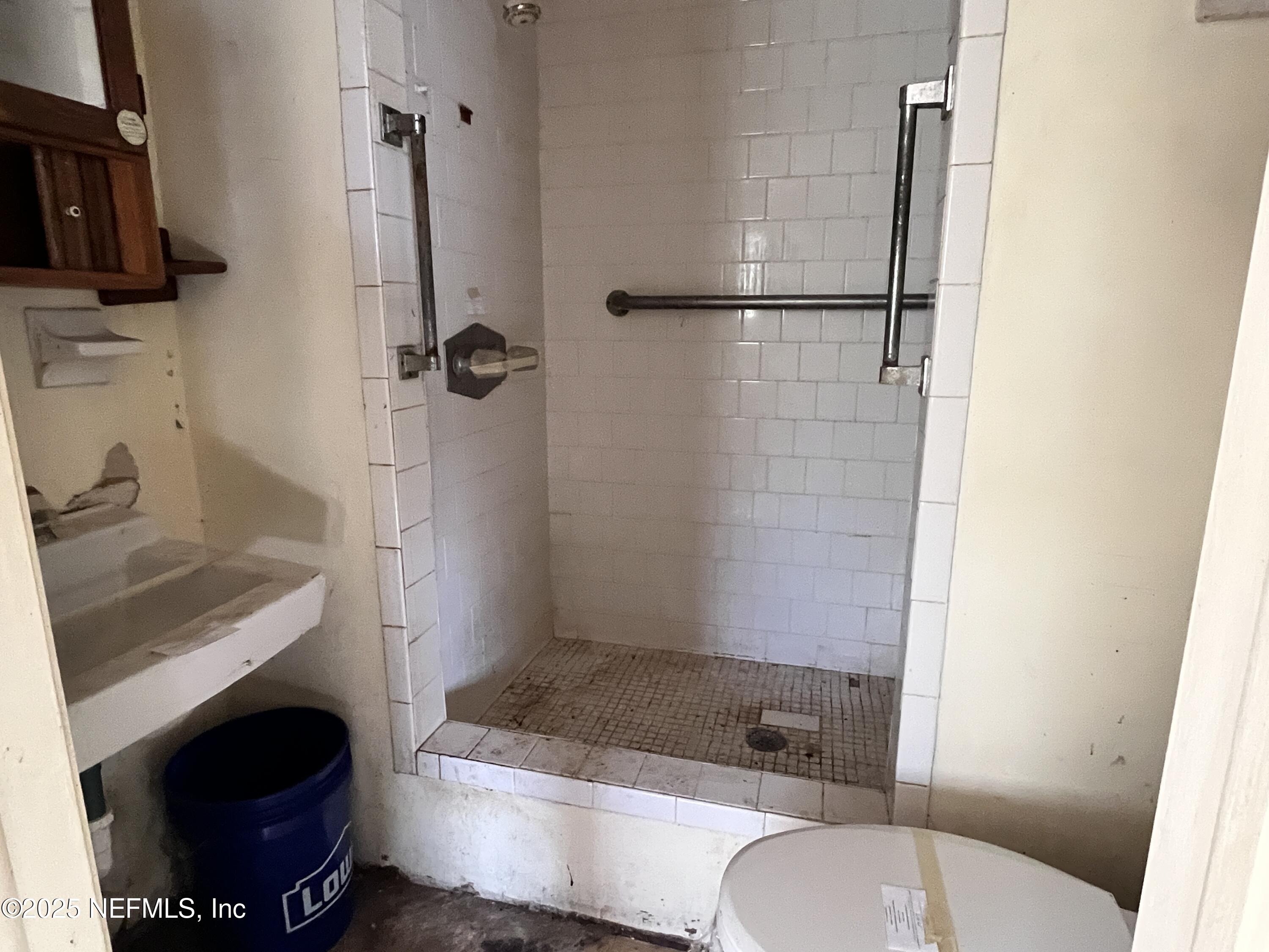 2833 Huffman Boulevard Jacksonville, FL 32246 - Photo 11 of 13 a bathroom with a sink a toilet and shower