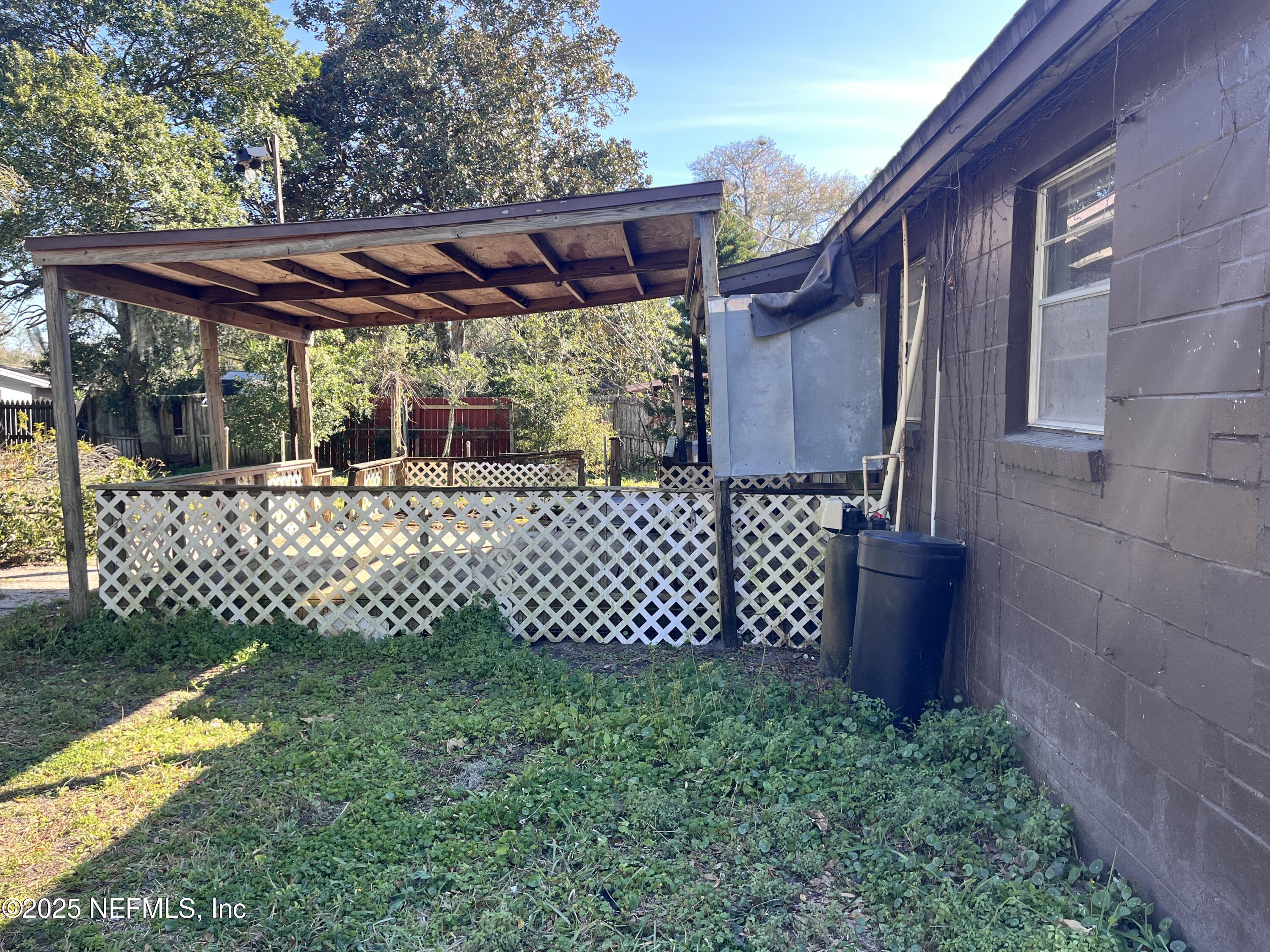 2833 Huffman Boulevard Jacksonville, FL 32246 - Photo 13 of 13 a view of a yard with a bench and wooden fence
