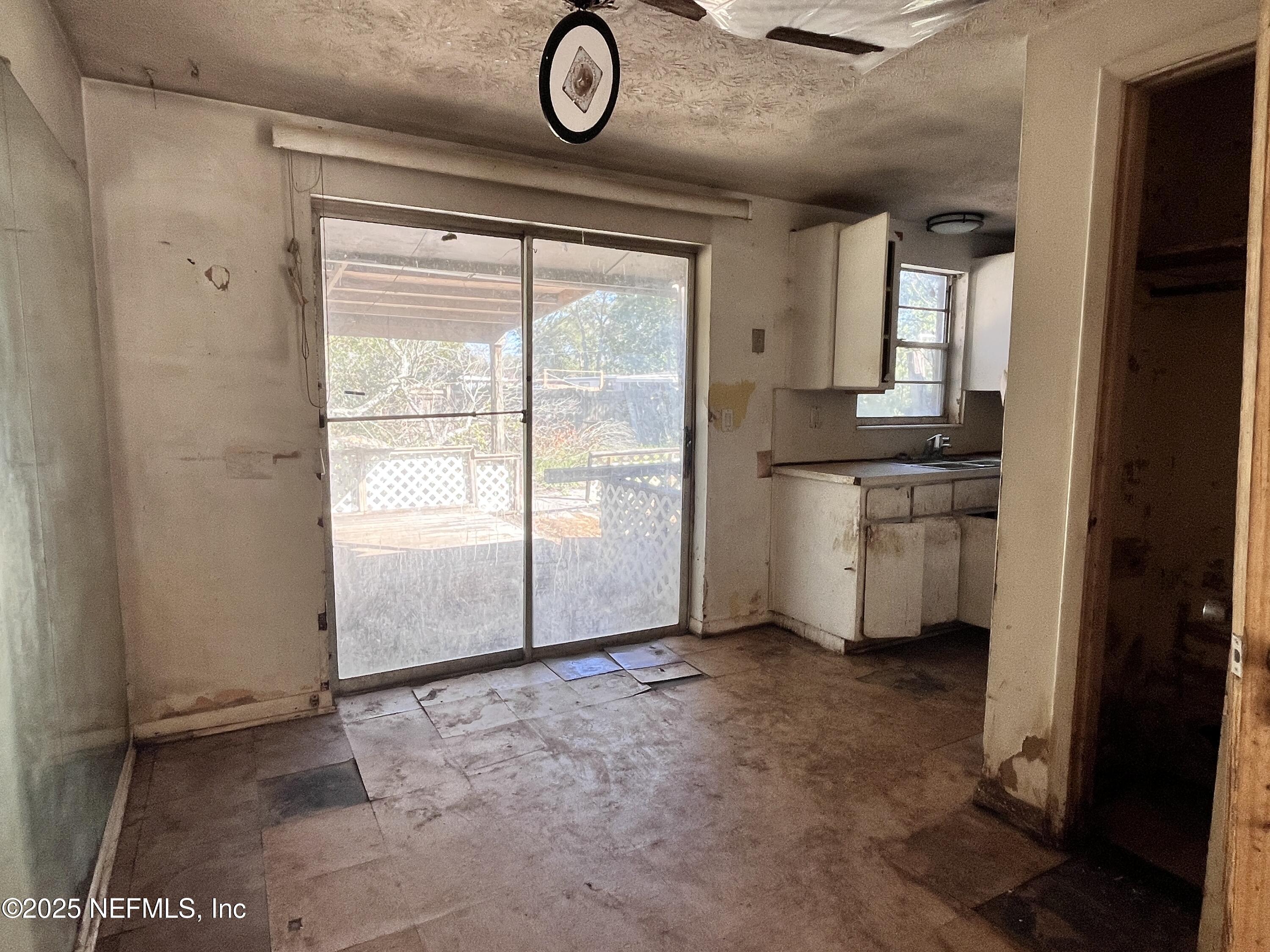 2833 Huffman Boulevard Jacksonville, FL 32246 - Photo 4 of 13 an empty room with windows and closet