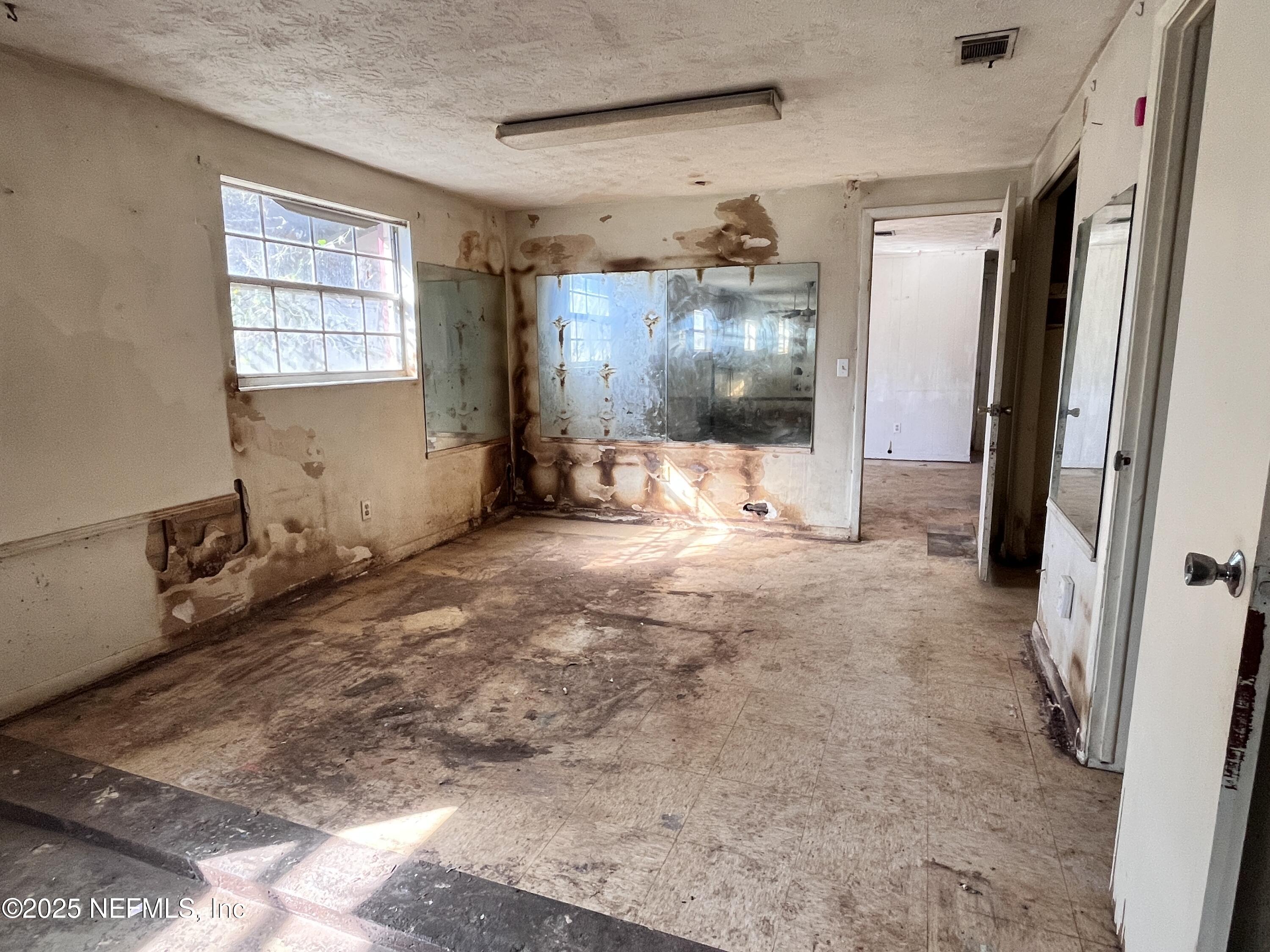 2833 Huffman Boulevard Jacksonville, FL 32246 - Photo 7 of 13 a view of a livingroom with wooden floor and windows