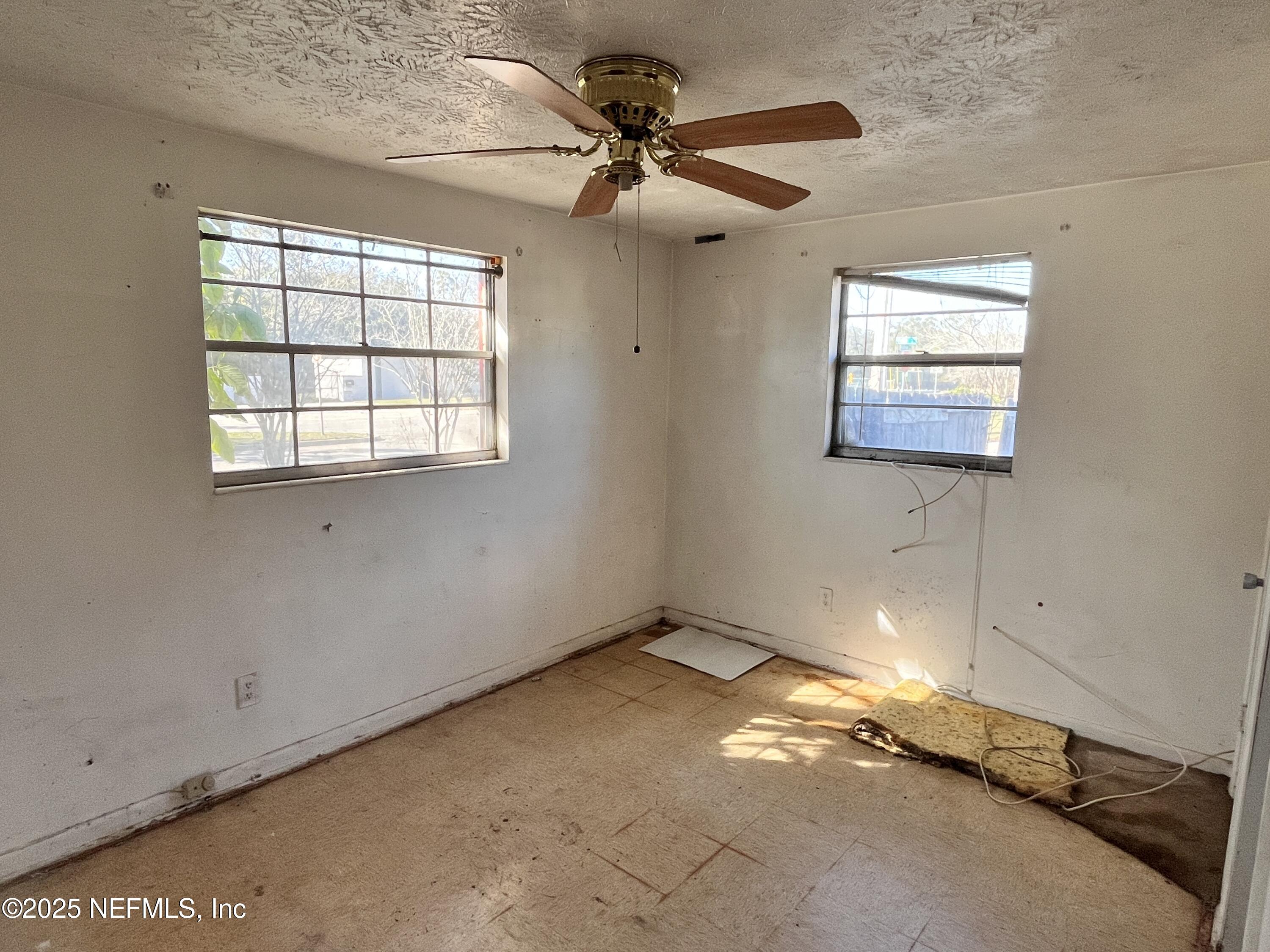 2833 Huffman Boulevard Jacksonville, FL 32246 - Photo 9 of 13 an empty room with windows and fan