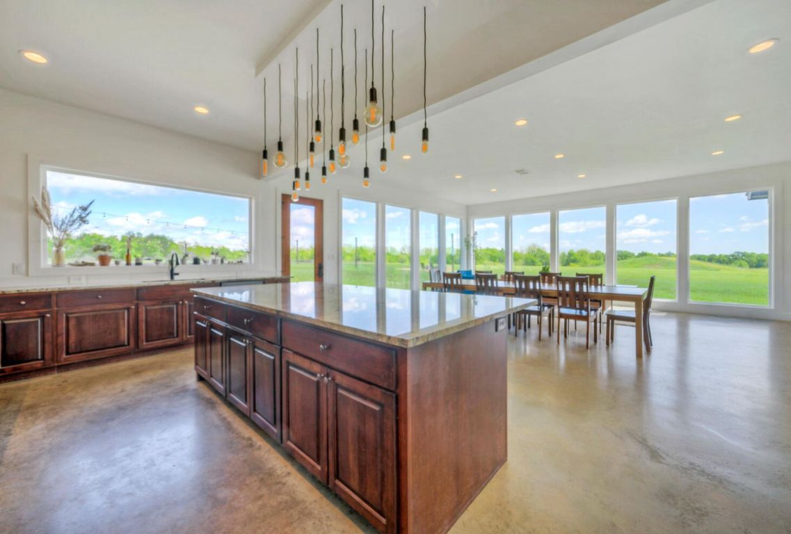0 County Road 463 Elgin, TX 78621 - Photo 12 of 37 a view of a dining room with furniture water view and large windows