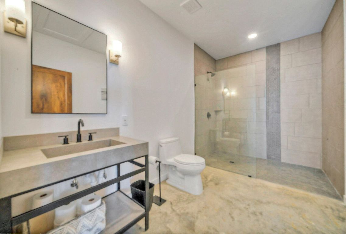 0 County Road 463 Elgin, TX 78621 - Photo 23 of 37 a bathroom with a sink a toilet a mirror and shower