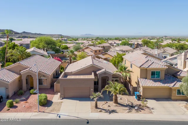 an aerial view of a house with a yard