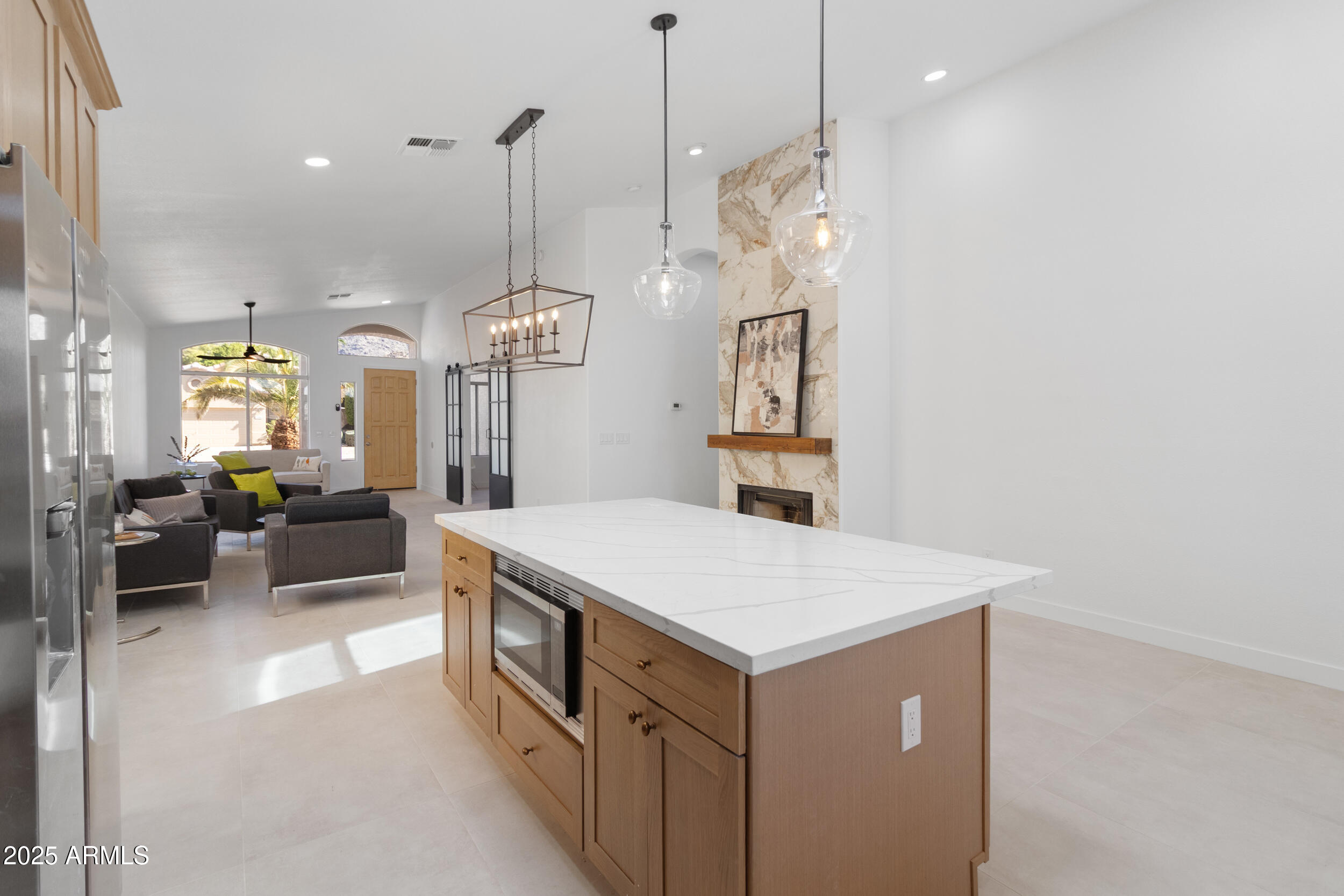 1349 East Sapium Way Phoenix, AZ 85048 - Photo 9 of 33 a large kitchen with kitchen island a stove a sink a center island a dining table and chairs
