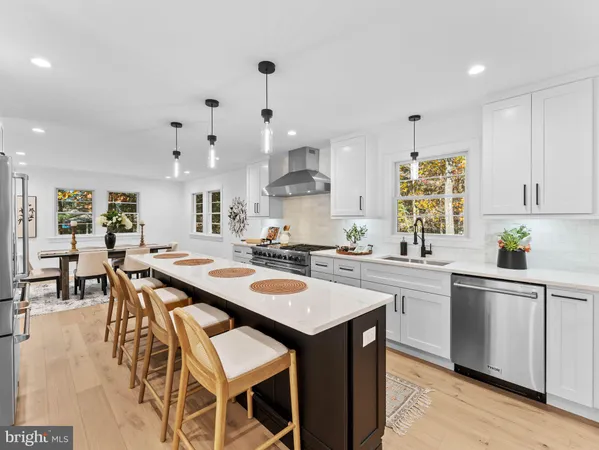 a kitchen with stainless steel appliances a stove a sink and a refrigerator
