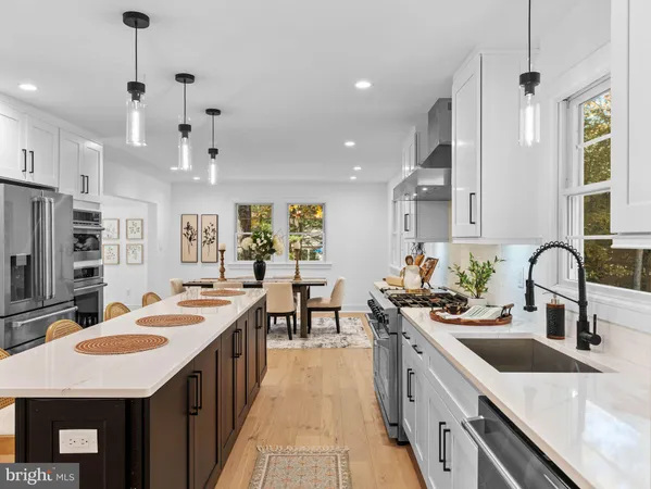 a kitchen with kitchen island a stove a sink and a refrigerator