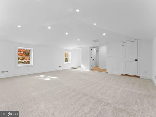 an empty room with a ceiling fan and a window