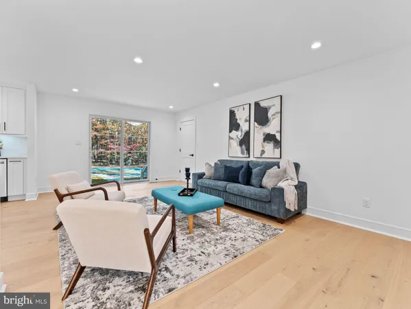 a living room with furniture and kitchen view