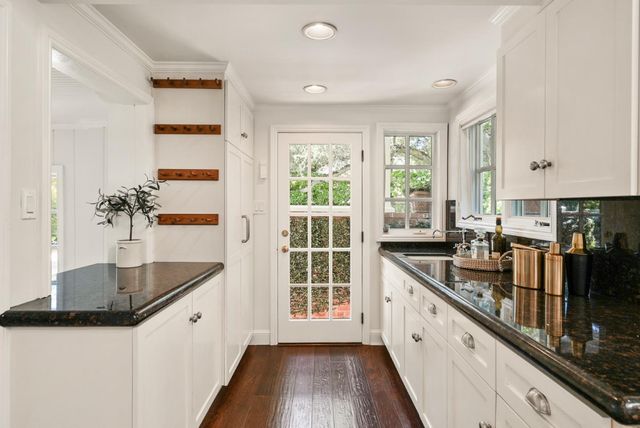 a kitchen with granite countertop a sink and a stove