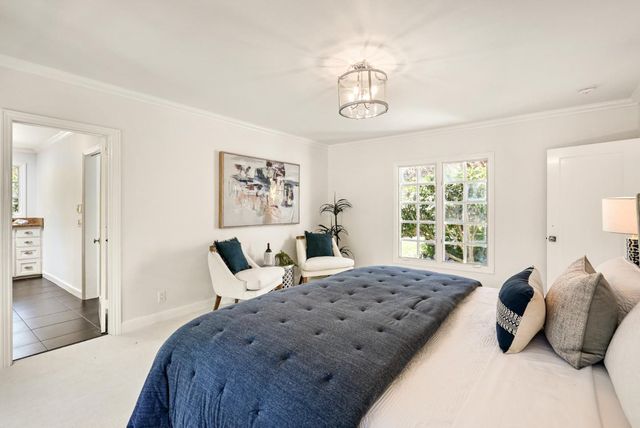 a bedroom with a large bed and a window