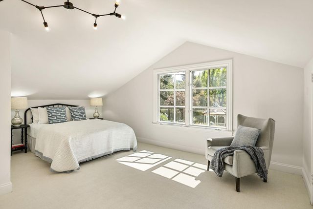 a bedroom with bed and a window