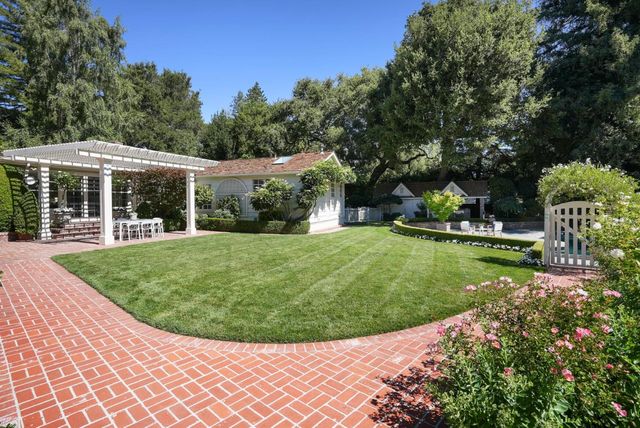 a view of a house with a backyard porch and sitting area