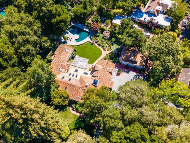 an aerial view of a house with a yard and garden view