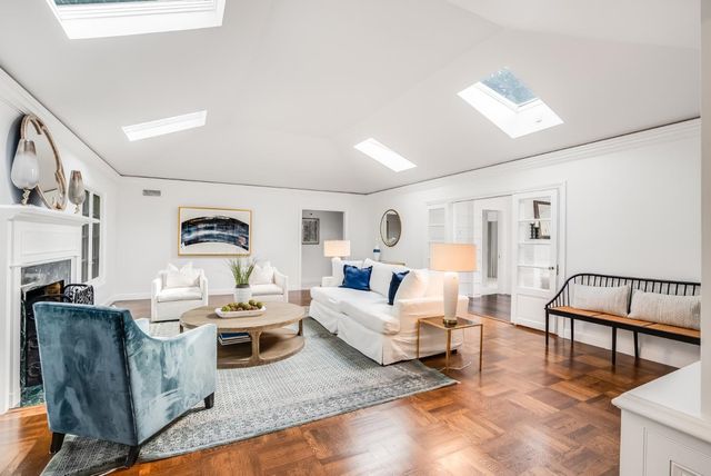 a living room with furniture a rug and a window