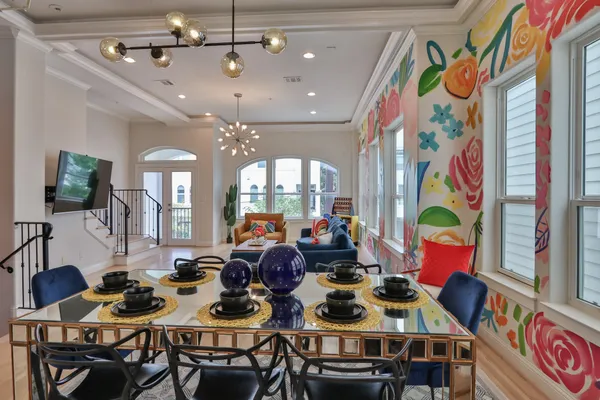 a view of a dining room with furniture and chandelier
