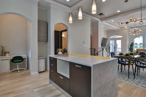 a view of a kitchen counter space and dining room