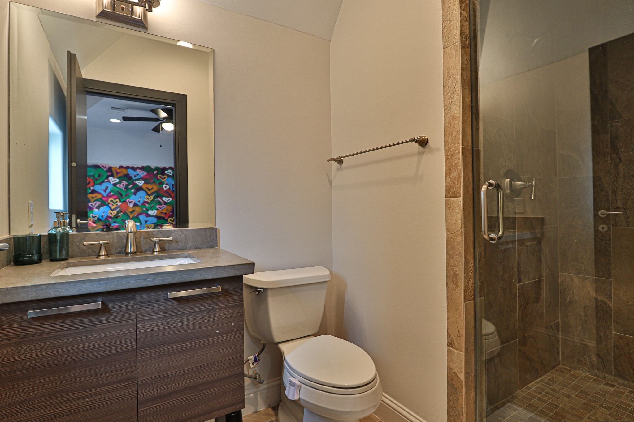 4114 Driscoll Street Houston, TX 77098 - Photo 20 of 50 a bathroom with a sink a toilet a mirror and shower