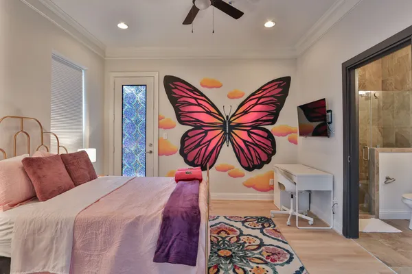 a bedroom with a bed and a chandelier