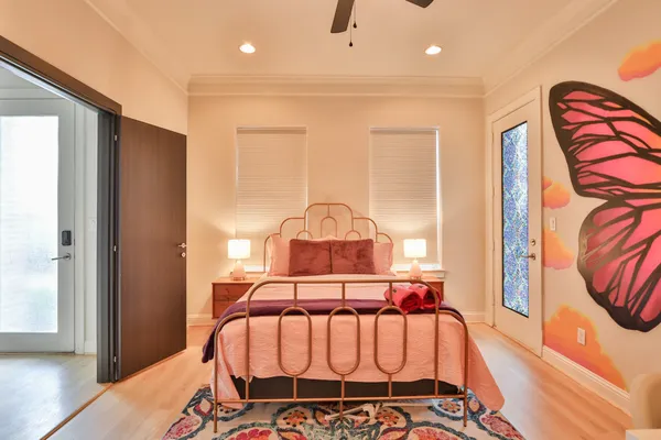 a bedroom with a bed and wooden floor