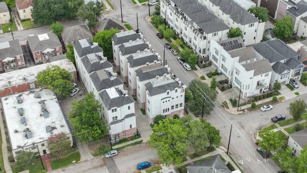 an aerial view of multiple houses with yard