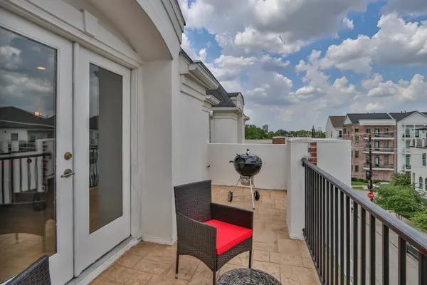 a view of a balcony with an outdoor seating