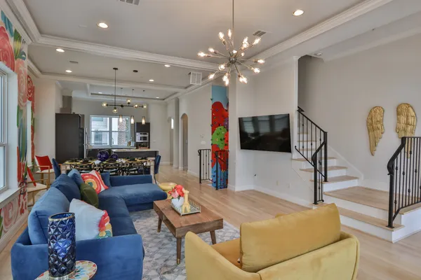 a living room with furniture and wooden floor