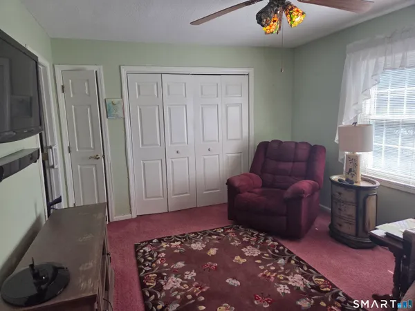 a room with furniture a rug and a window
