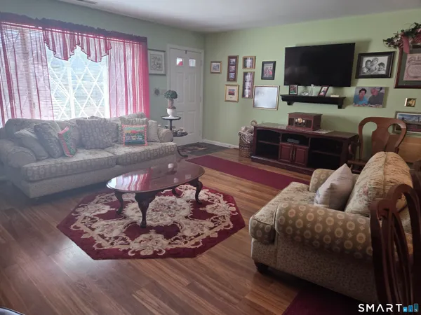 a living room with furniture and wooden floor