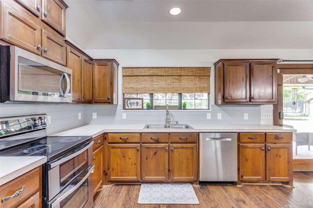 950 Johnson Bend Road Weatherford, TX 76088 - Photo 11 of 40 a kitchen with a sink stove and cabinets