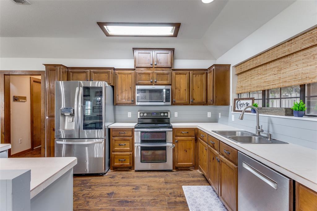 950 Johnson Bend Road Weatherford, TX 76088 - Photo 12 of 40 a kitchen with stainless steel appliances granite countertop a refrigerator stove and sink