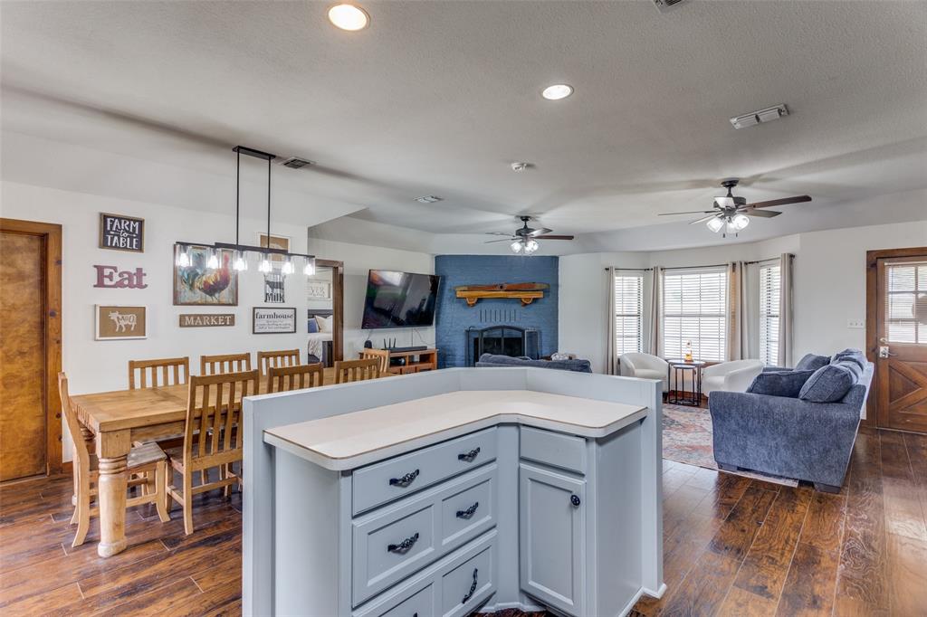 950 Johnson Bend Road Weatherford, TX 76088 - Photo 14 of 40 a view of a dining room with furniture window and wooden floor