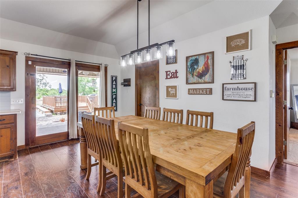 950 Johnson Bend Road Weatherford, TX 76088 - Photo 15 of 40 a view of a dining room with furniture window and wooden floor