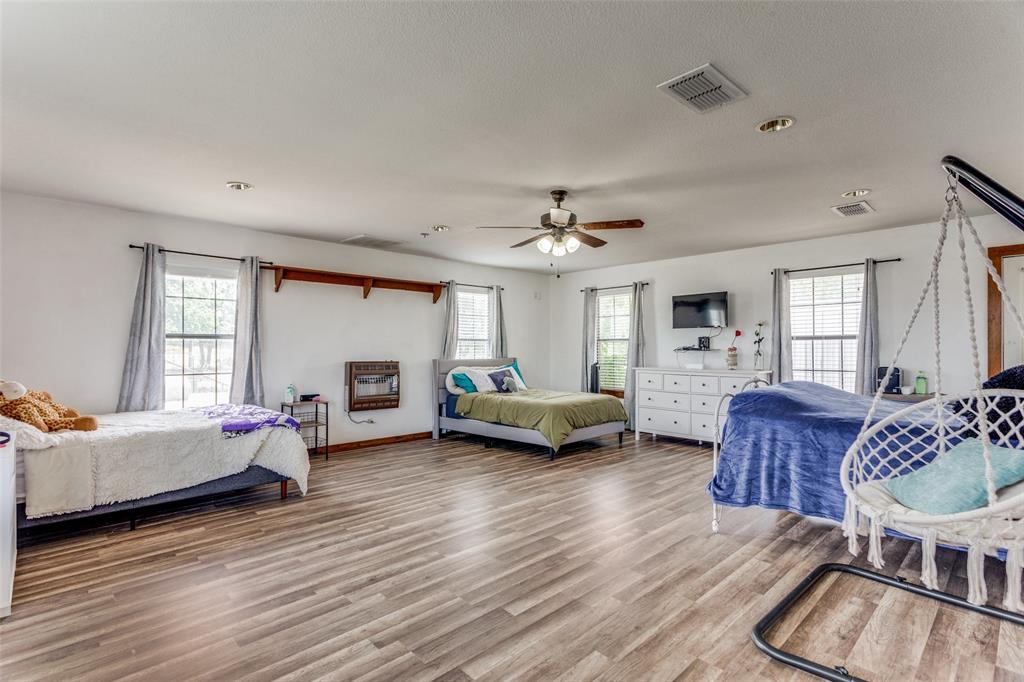 950 Johnson Bend Road Weatherford, TX 76088 - Photo 23 of 40 a living room with furniture and a wooden floor