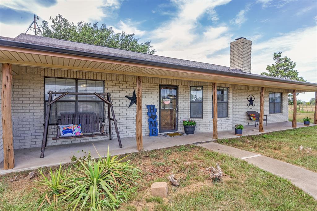 950 Johnson Bend Road Weatherford, TX 76088 - Photo 5 of 40 a front view of a house with a garden and plants