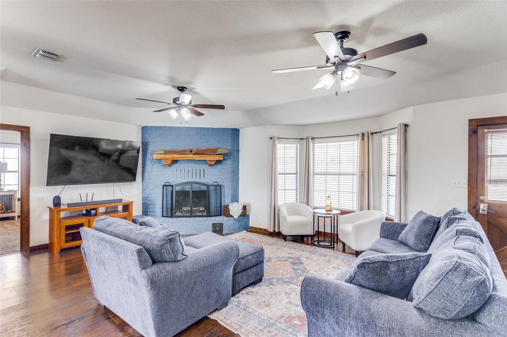 950 Johnson Bend Road Weatherford, TX 76088 - Photo 6 of 40 a living room with furniture a fireplace and a flat screen tv